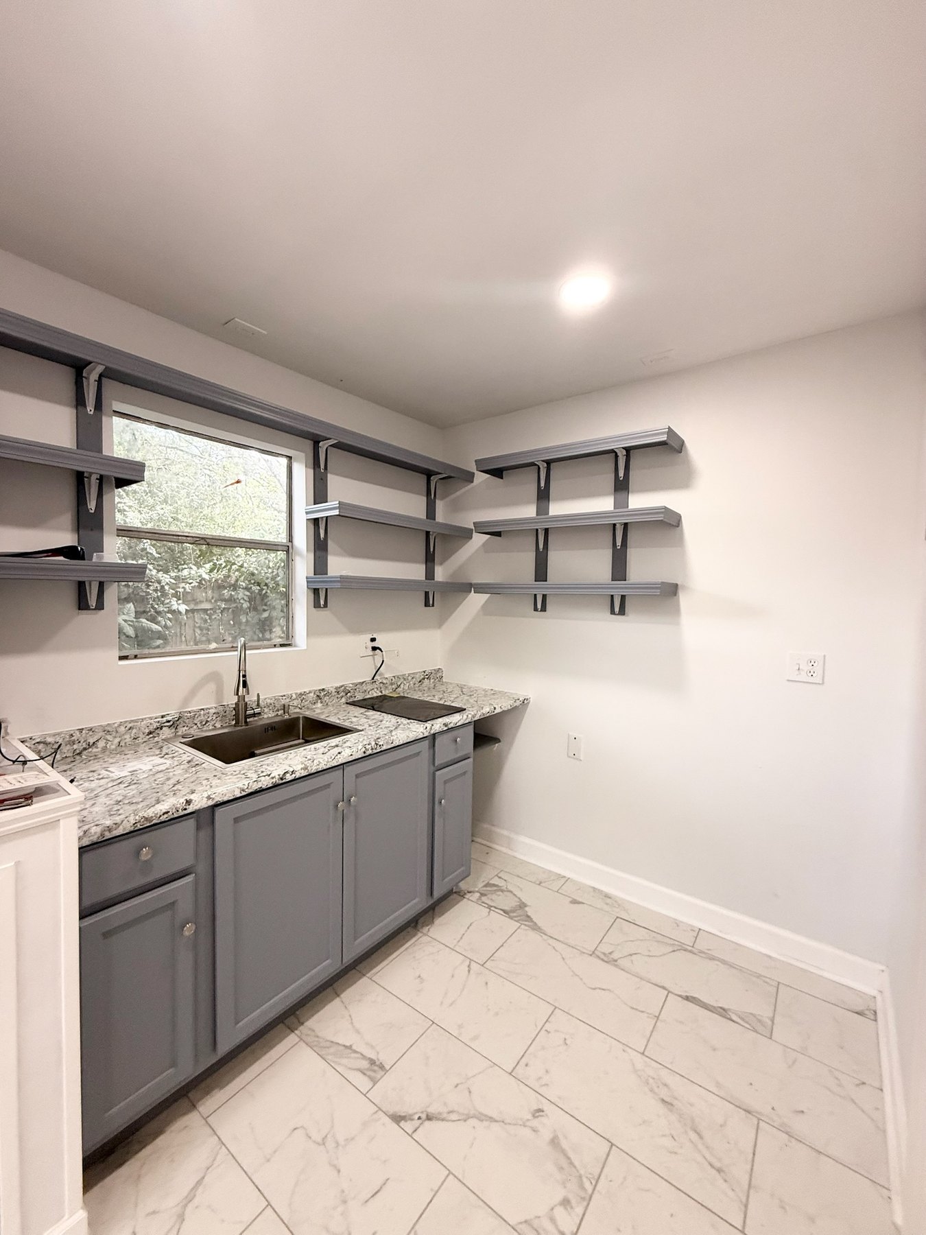 Kitchen shelves and cooktop at Stonegate Studio